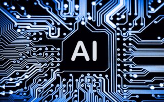 A close-up image of a printed circuit board with glowing blue lines and patterns. In the center, a black hexagon contains the large, white letters "AI," symbolizing artificial intelligence technology.